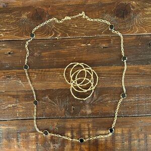 Set of five gold tone, bangle bracelets and long necklace with black rhinestones